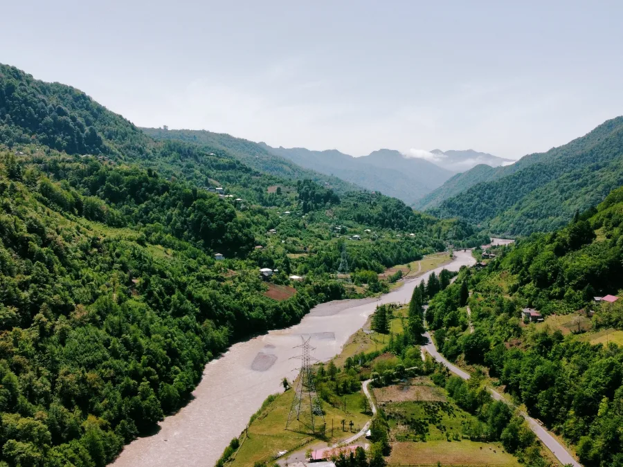 A river valley in mountain Adjara, with wooded slopes and a road along the water