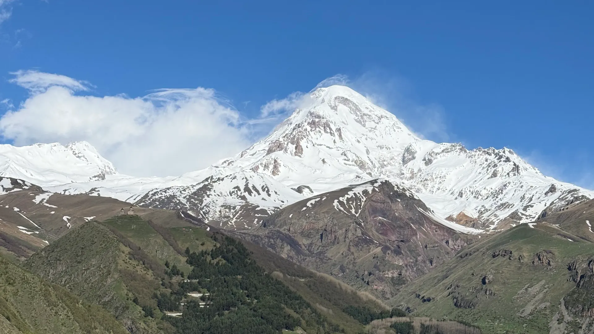 Snow-capped Mount Kazbek above Stepantsminda on a clear day