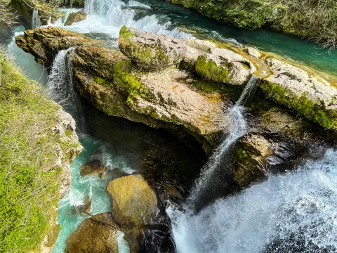 Turquoise water and small waterfalls in Martvili Canyon